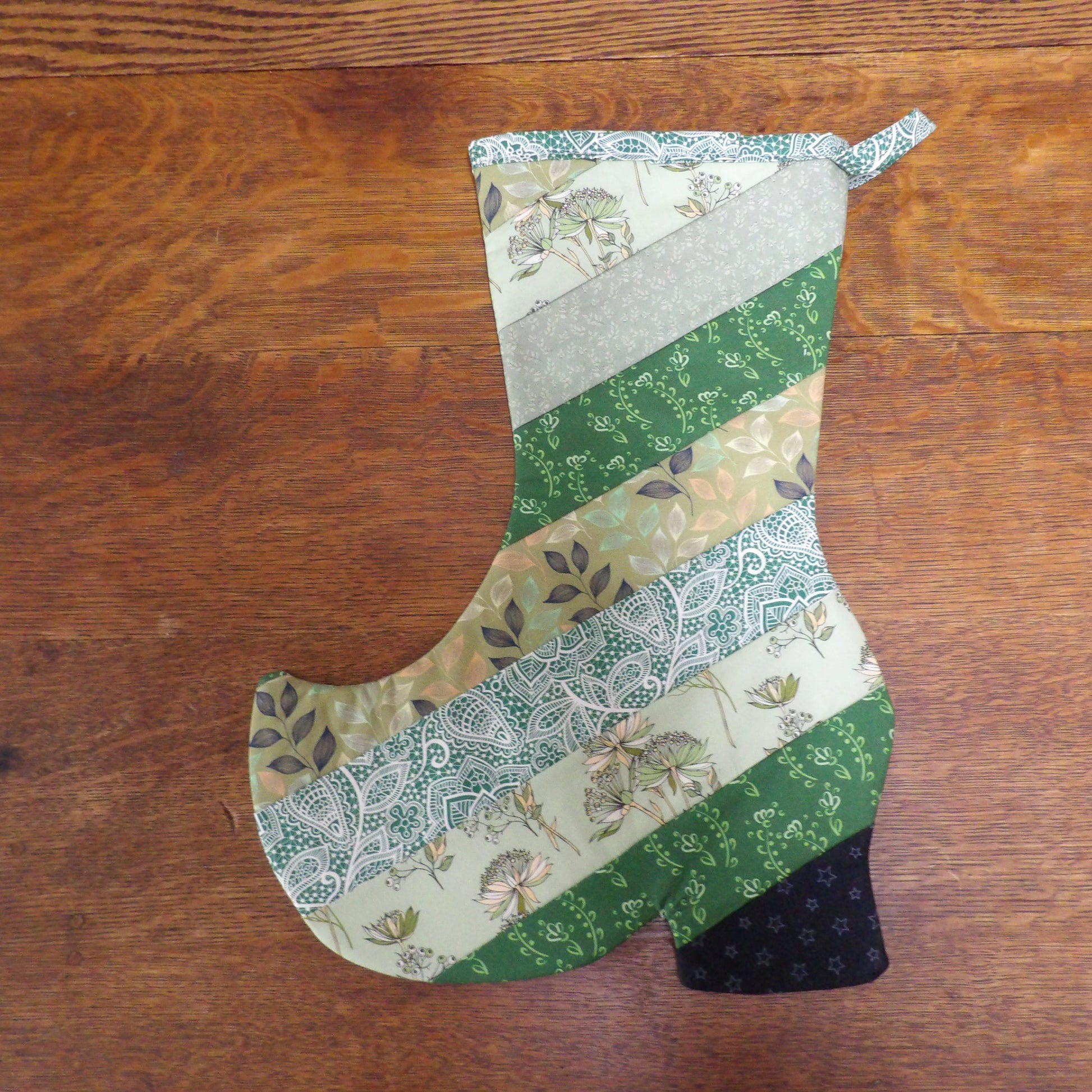 Patchwork-style Christmas stocking on a wooden surface